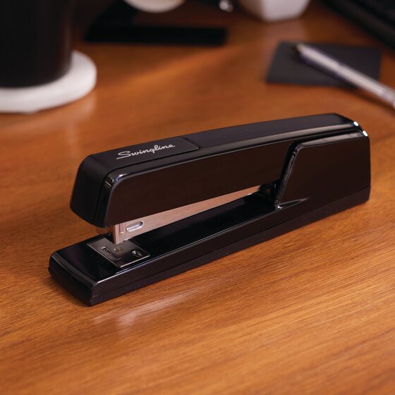 Black Swingline 747 Classic stapler on a wooden desk