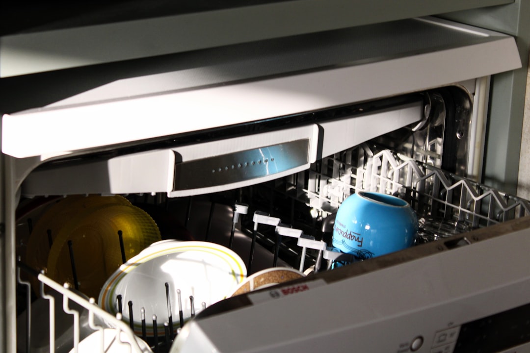 Dishwasher loaded with a mug as part of an after-dinner kitchen cleanup routine
