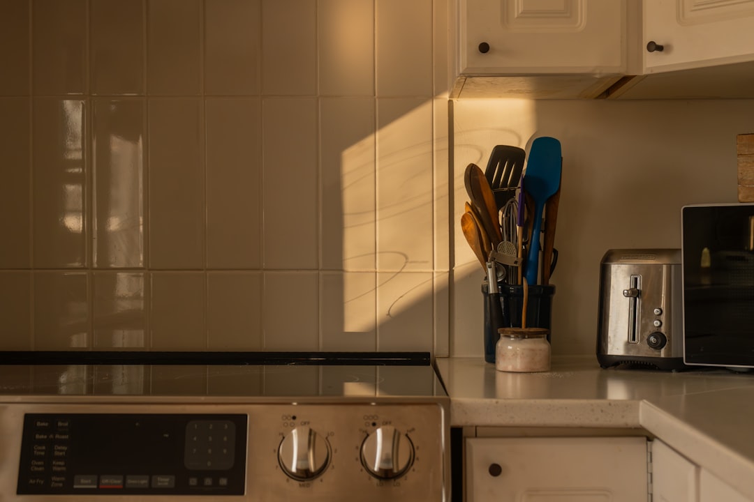 Kitchen counter with toaster and utensils at sunset, showing realistic items that may stay on a frequently used counter