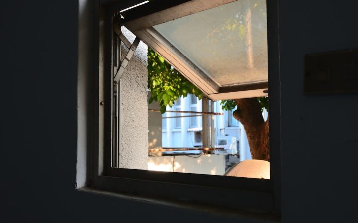 Open window bringing fresh air into a bright home, illustrating ventilation as part of an odor-control routine