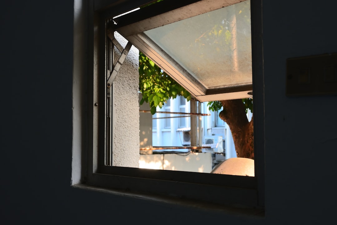 Open window bringing fresh air into a bright home, illustrating ventilation as part of an odor-control routine