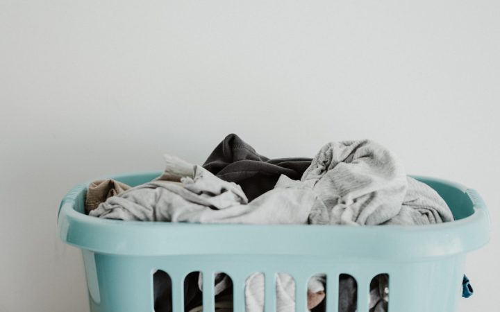Laundry basket filled with clean clothes in a home, illustrating how laundry can become visible clutter in a small space