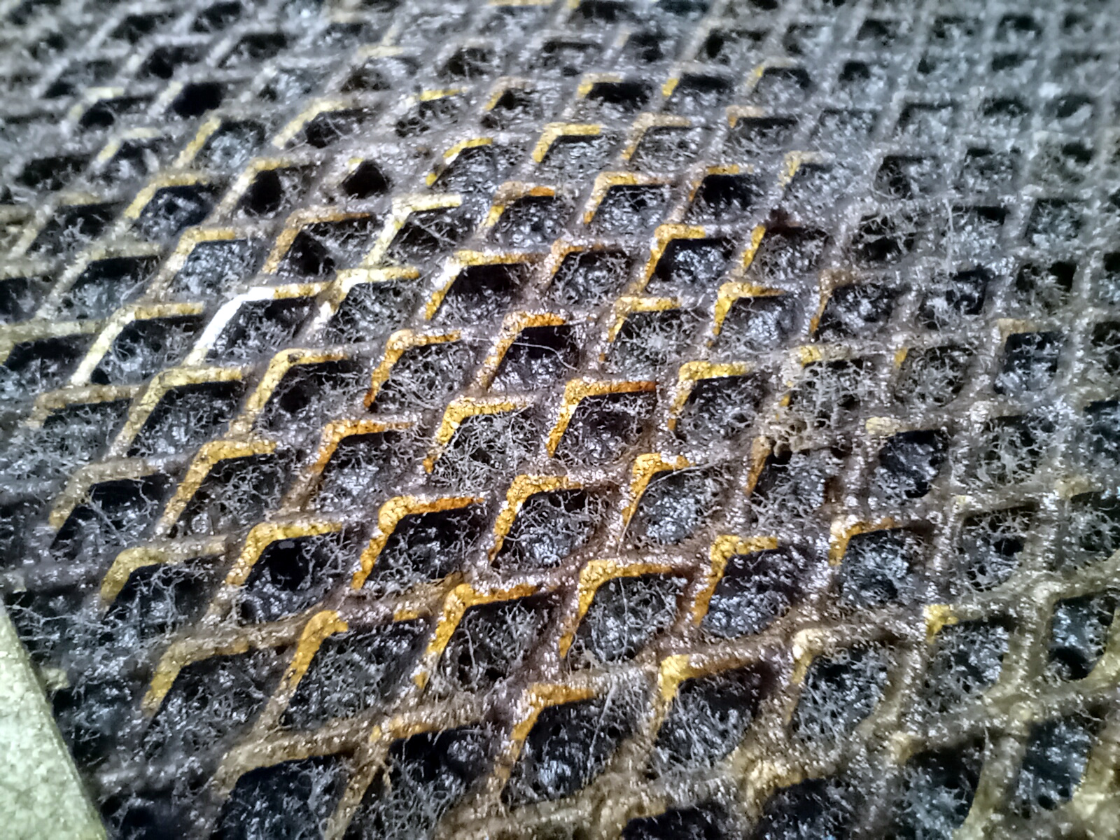 Close-up of residue on a metal hood filter