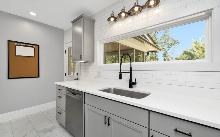 Bright small kitchen with clear counters and a clean sink, illustrating an everyday cleaning system for a compact family kitchen