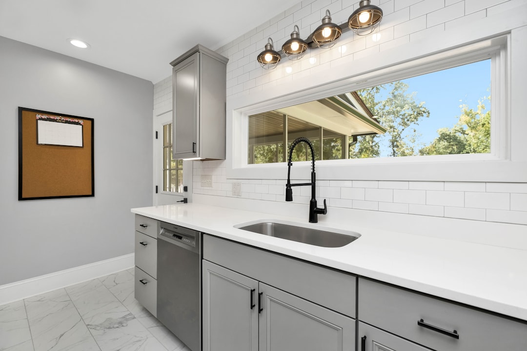 Bright small kitchen with clear counters and a clean sink, illustrating an everyday cleaning system for a compact family kitchen