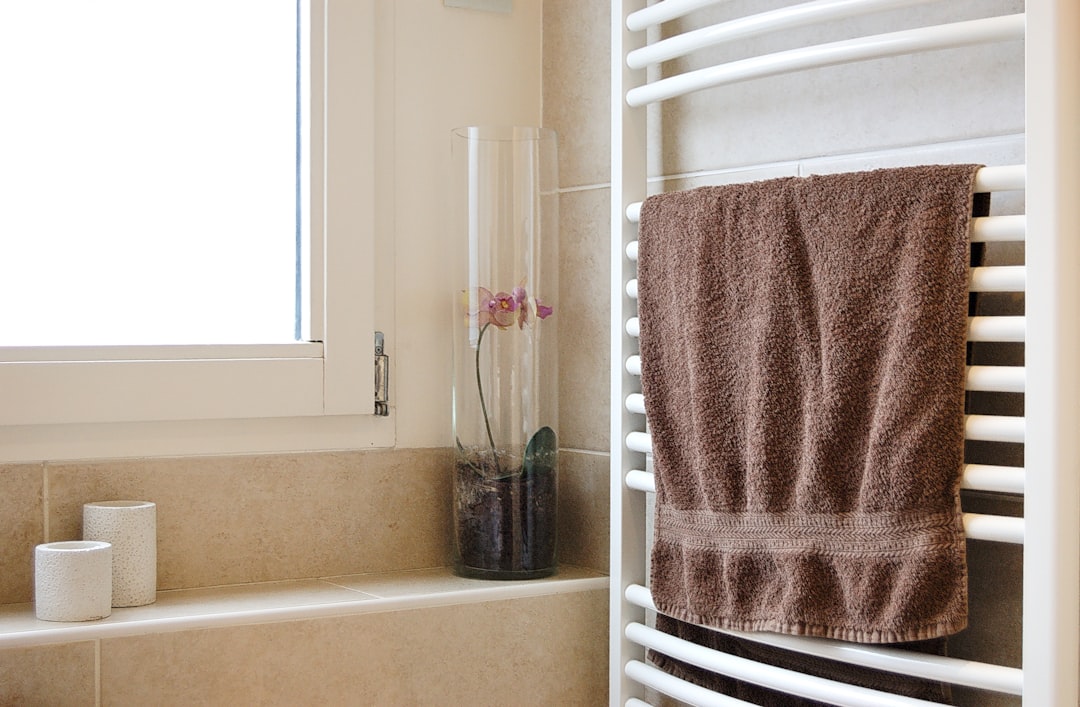 Towel hanging on a rack in a bathroom, illustrating the importance of letting damp textiles dry fully