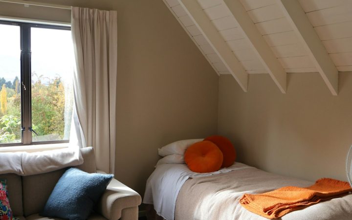 Small tidy bedroom with a simple bedside area
