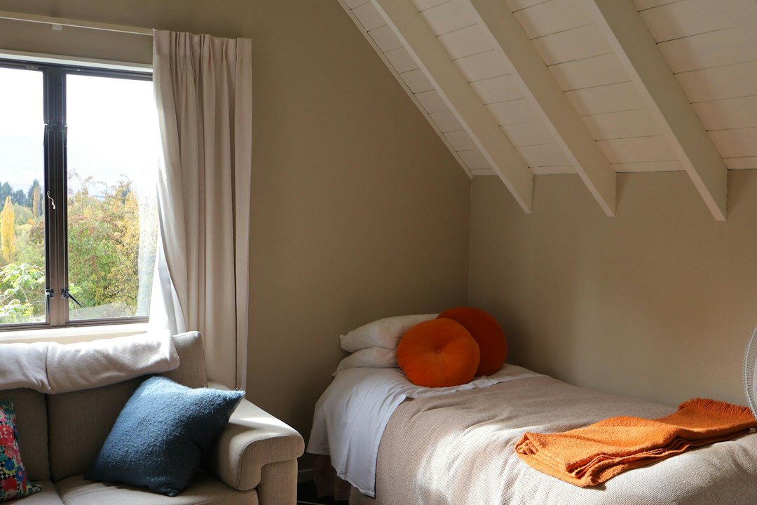 Small tidy bedroom with a simple bedside area