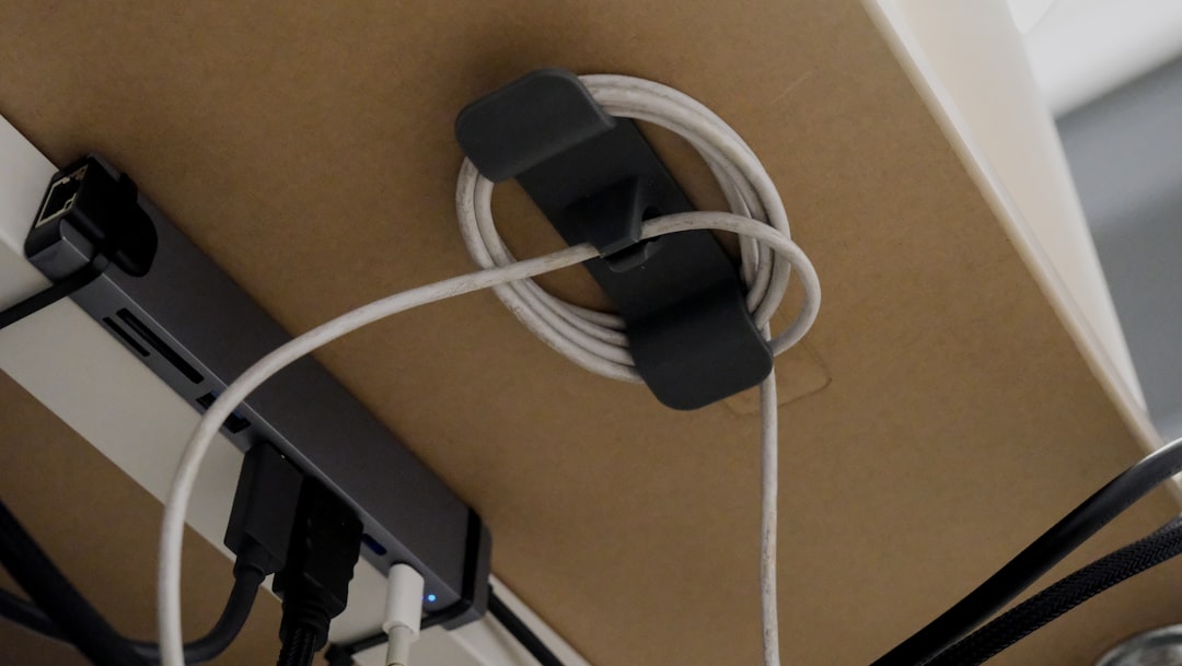 Charging cable neatly contained under a desk to reduce visible clutter
