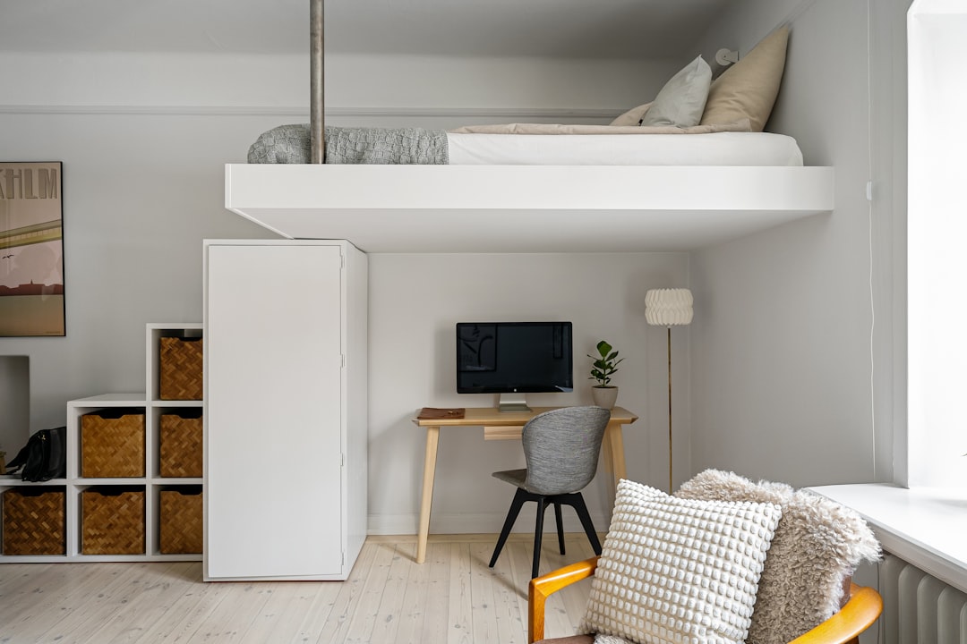 Small bedroom with loft bed and desk using limited space without crowding the floor