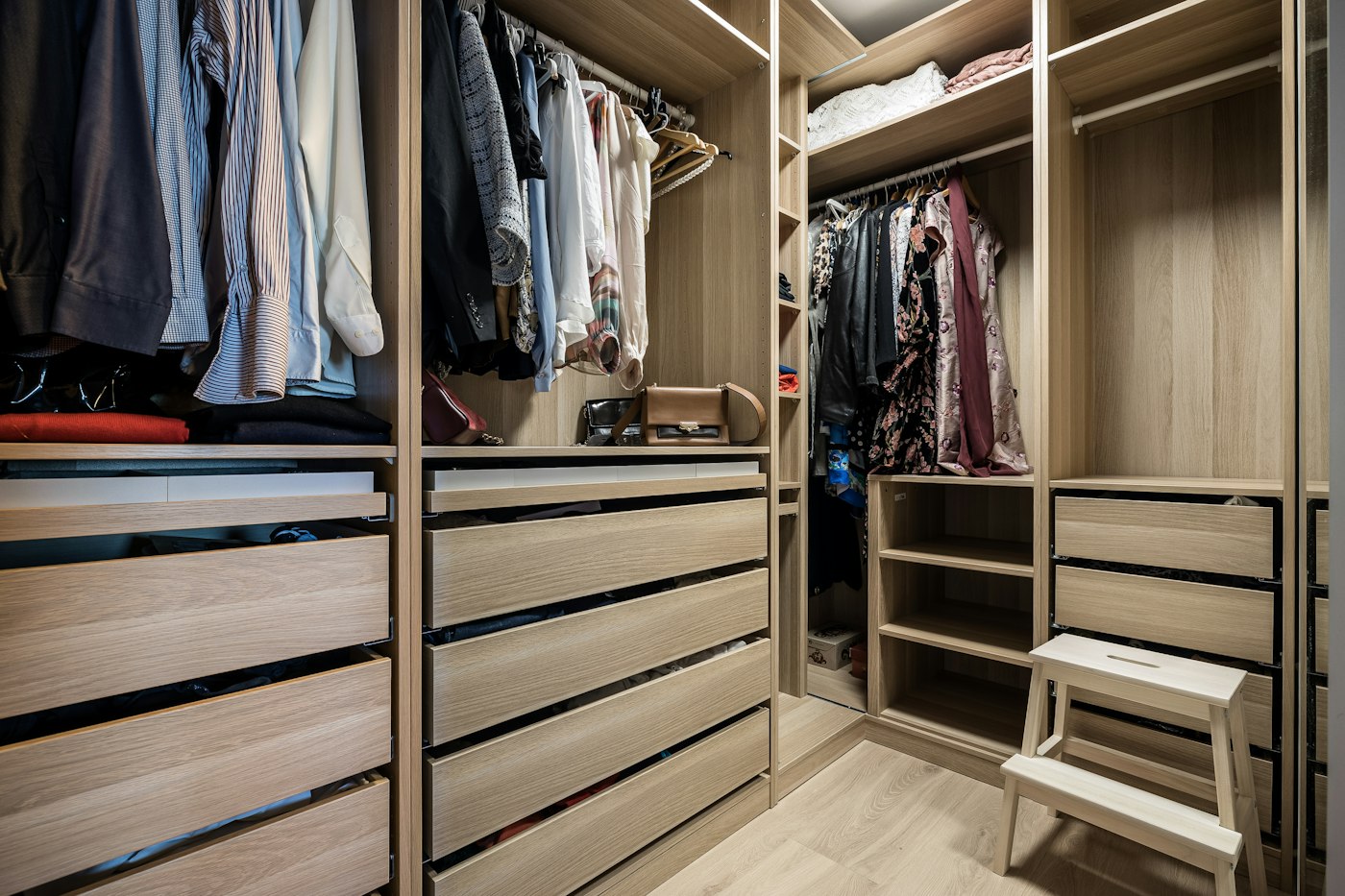 Organized walk-in wardrobe with open shelf space, illustrating the breathing room created after editing down possessions