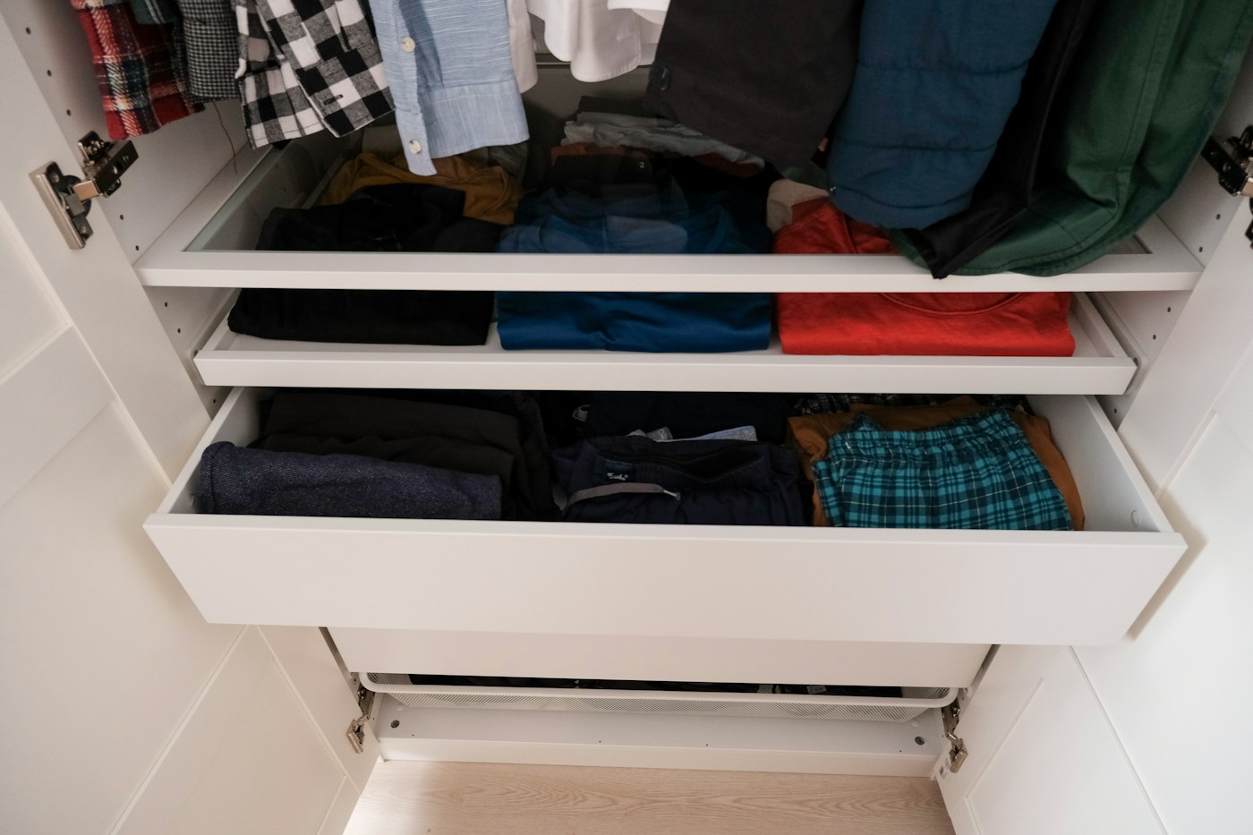 Small bedroom with accessible open clothing storage