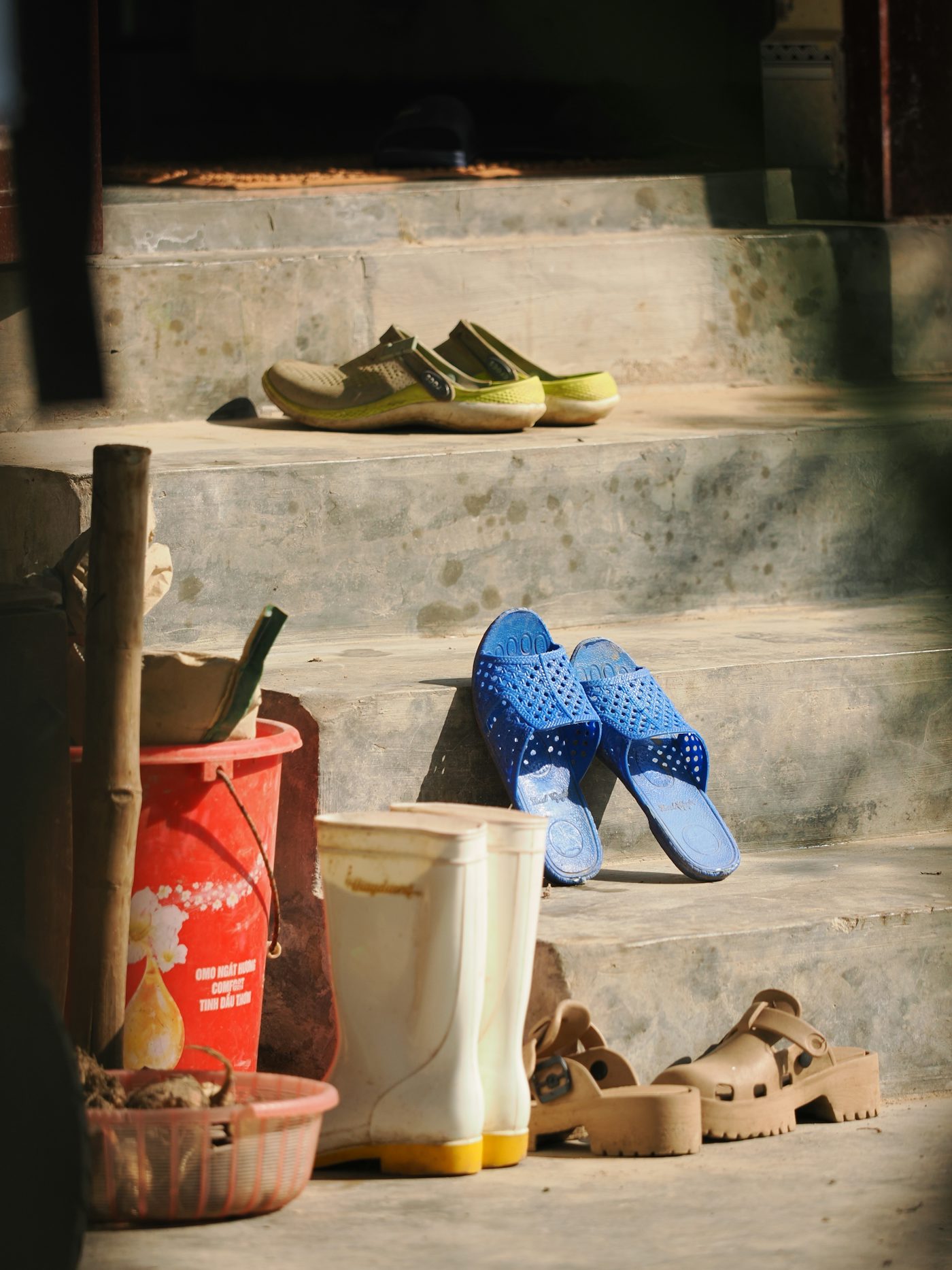 Various shoes and boots on outdoor steps