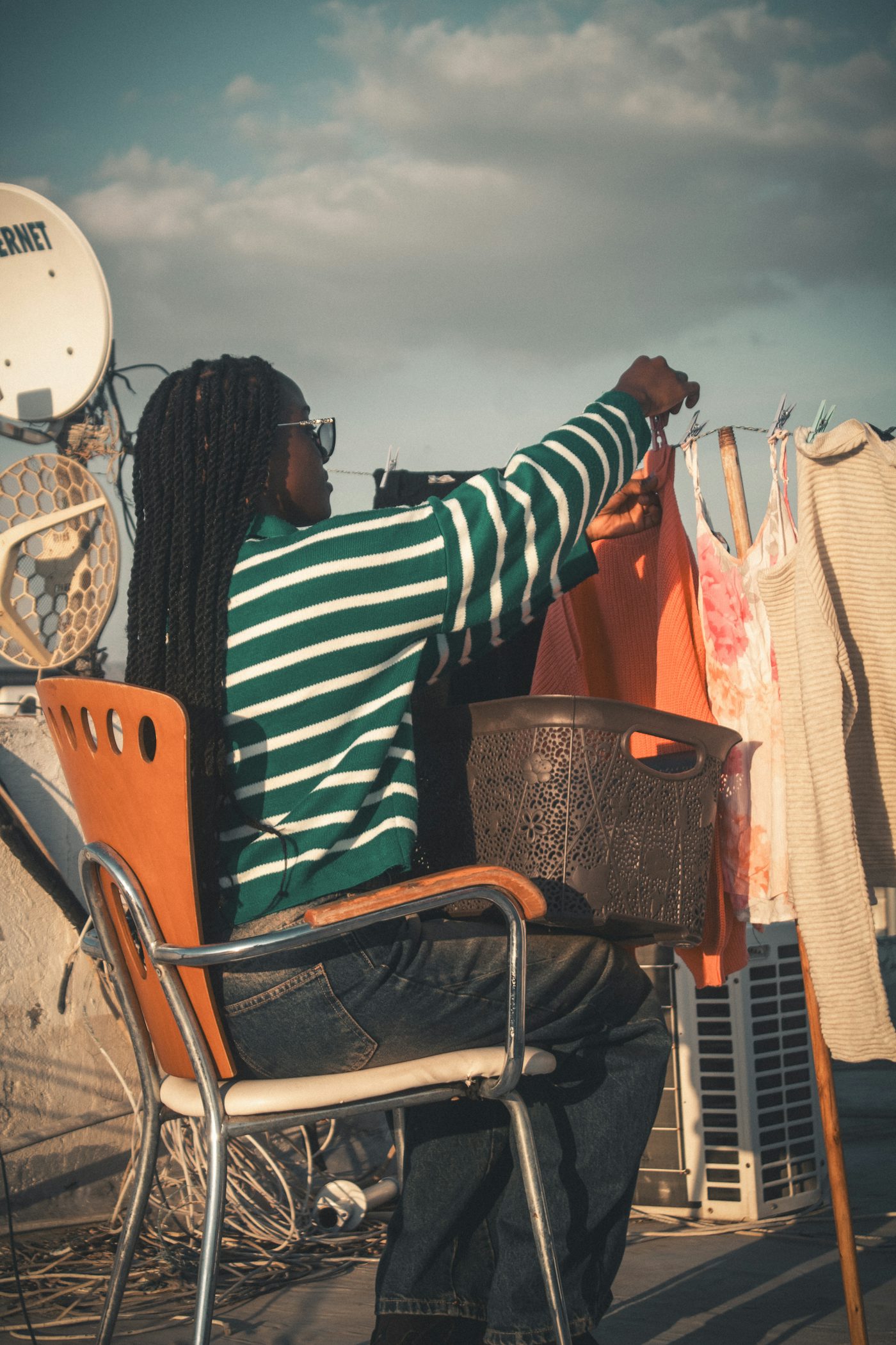 Woman hanging laundry on a clothesline outdoors