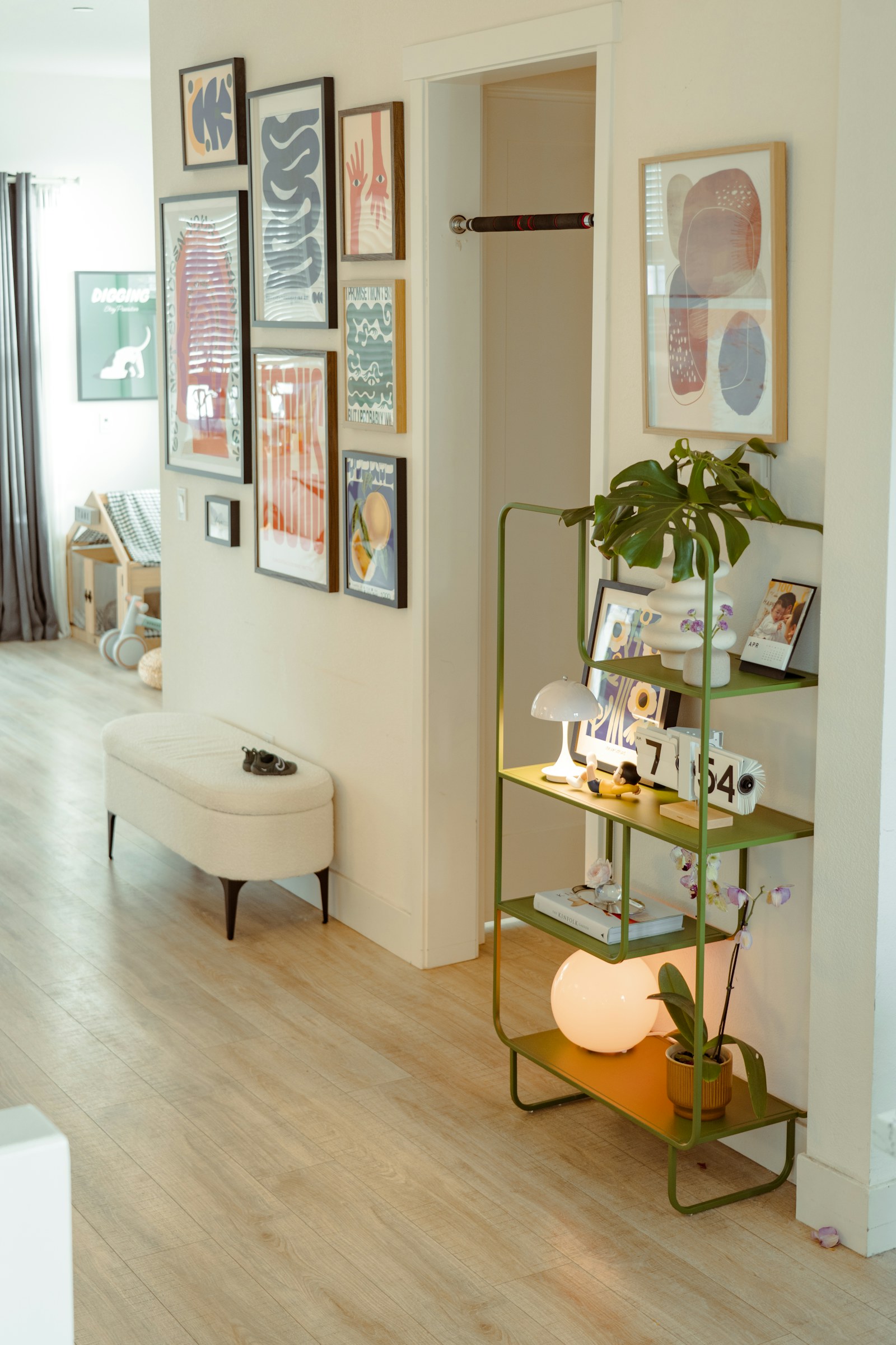 Hallway with art, bench, and green shelf