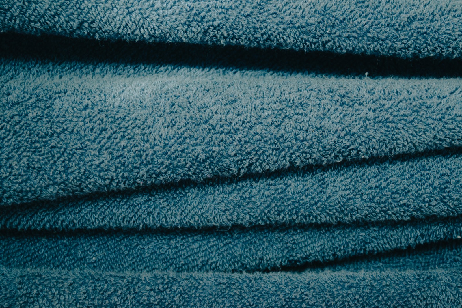 a close up of a pile of blue towels
