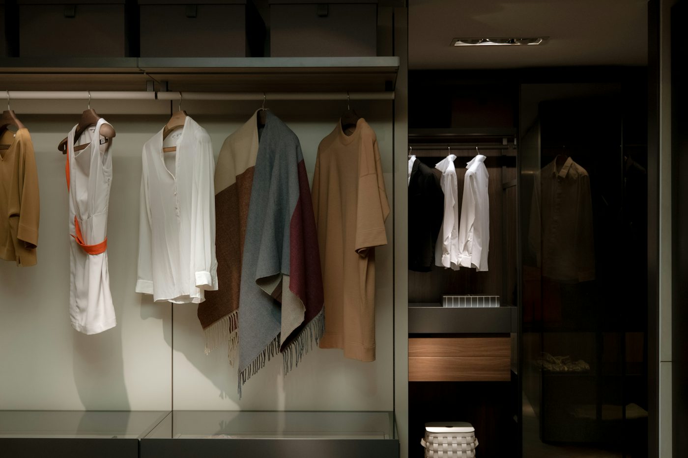 a bunch of clothes hanging on a rail in a closet