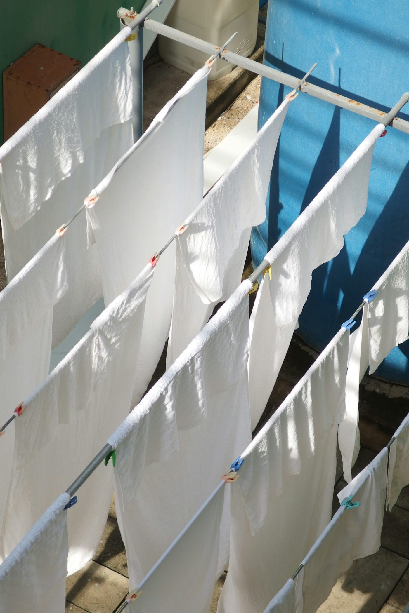 White laundry hanging on clotheslines in the sun