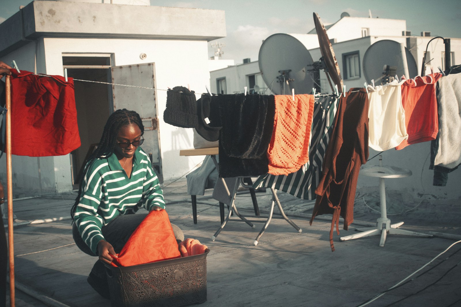 Woman folding laundry on a rooftop