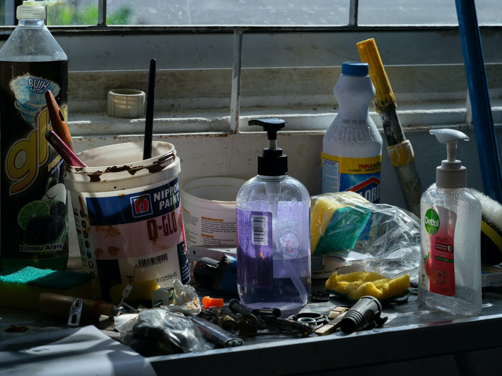 Assorted cleaning supplies and tools on a counter