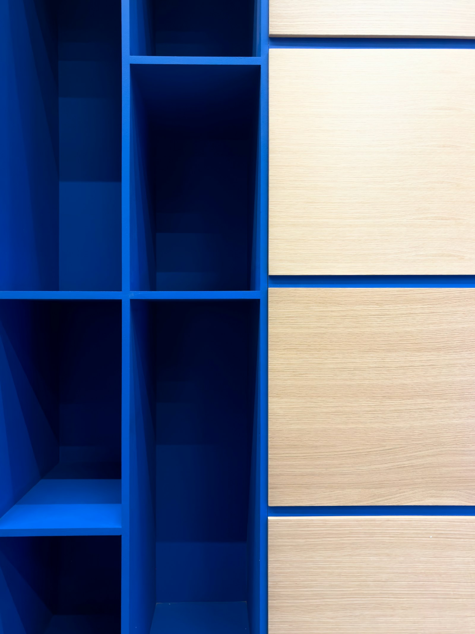 Blue shelving unit with light wood drawers