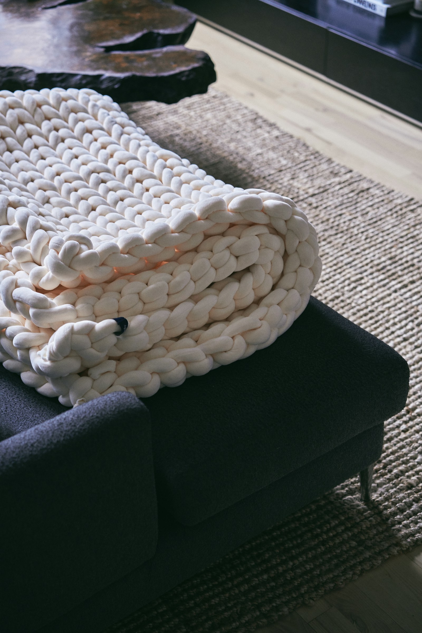 a pile of blankets sitting on top of a couch