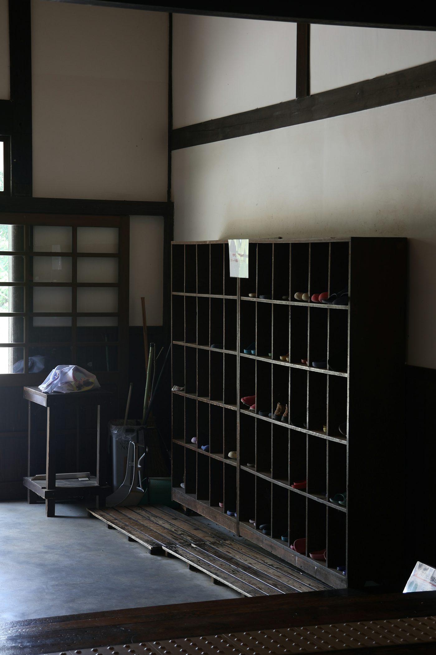 Traditional japanese entryway with wooden shoe rack and window