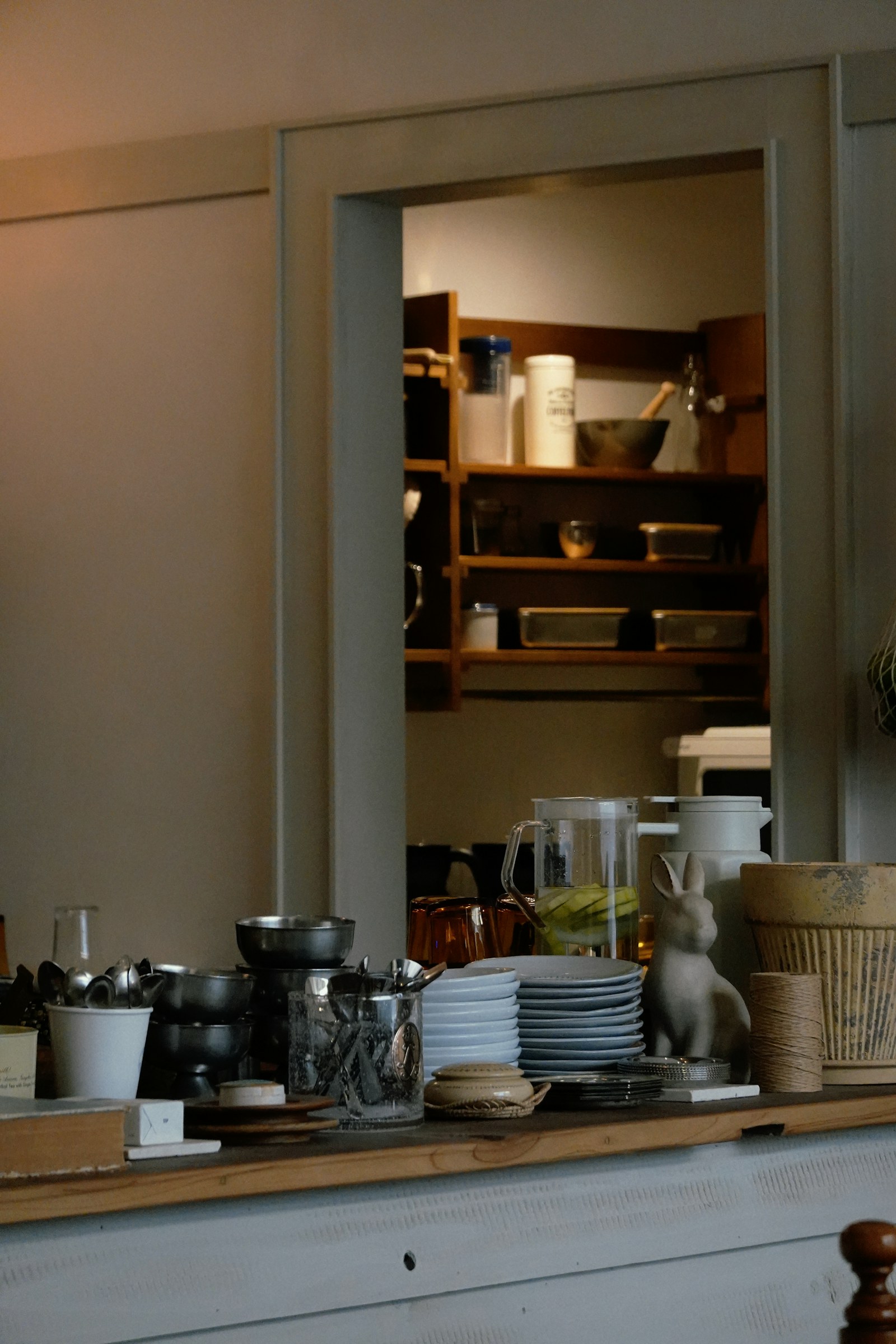 Kitchen pantry shelves stocked with jars and bowls