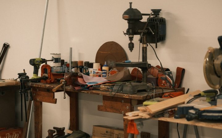 Small workbench covered with active tools and project materials