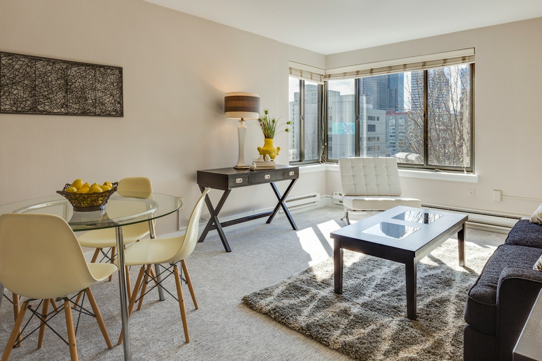 Dining table and chairs arranged within a limited apartment footprint