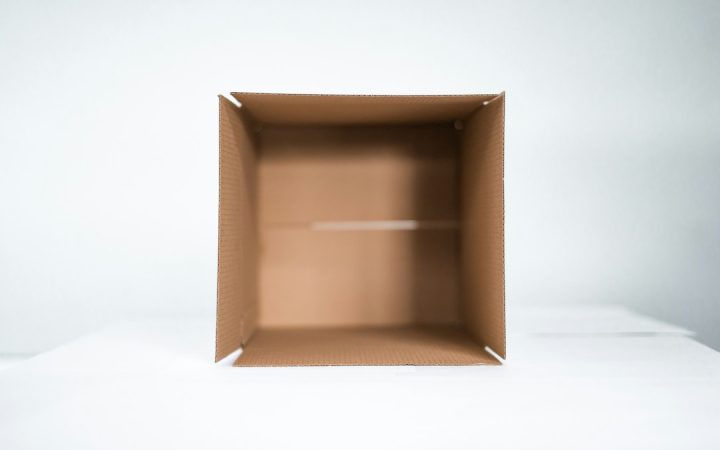Single open cardboard box used as a limited donation station