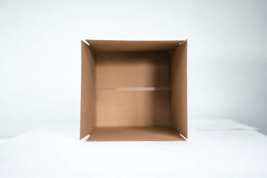 Single open cardboard box used as a limited donation station
