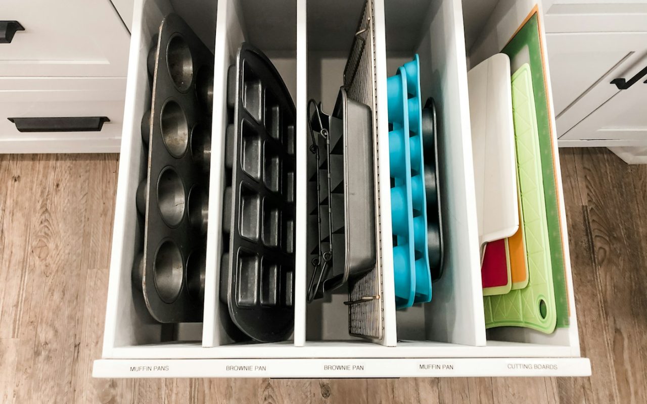Kitchen drawer with vertical dividers showing a simple space-efficient storage approach