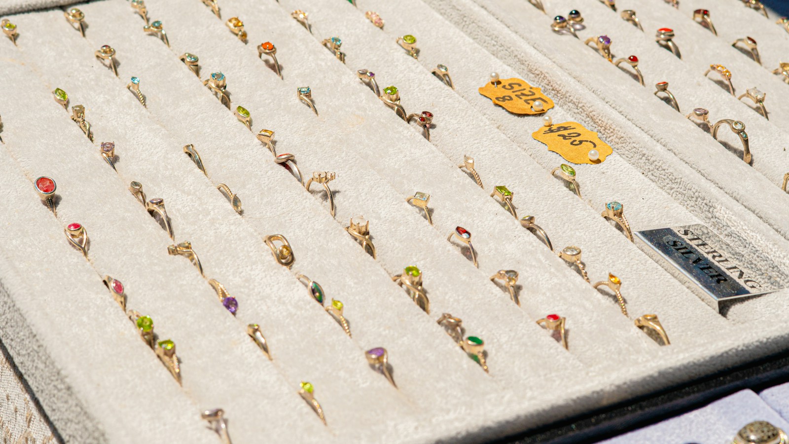 Rings separated into rows in a jewelry tray