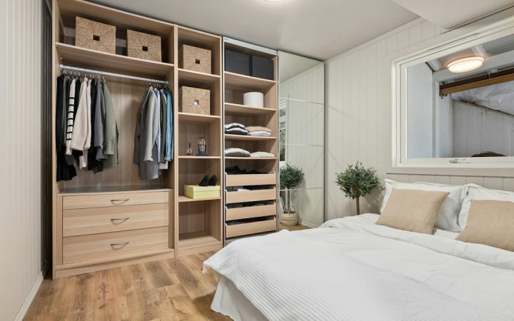 Small bedroom with a dresser positioned for everyday clothing access