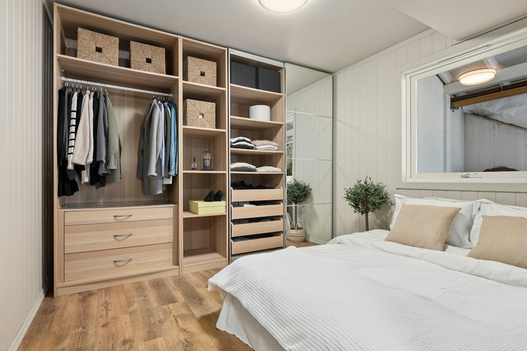 Small bedroom with a dresser positioned for everyday clothing access