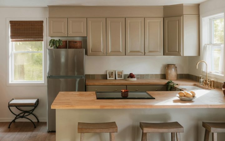 A modern kitchen with light wood countertops and island