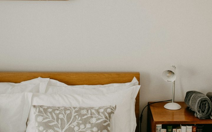 A cozy bedroom with a wooden bed and nightstand