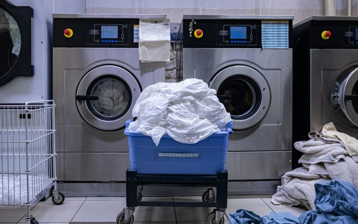 a laundry room with a washing machine and a laundry basket