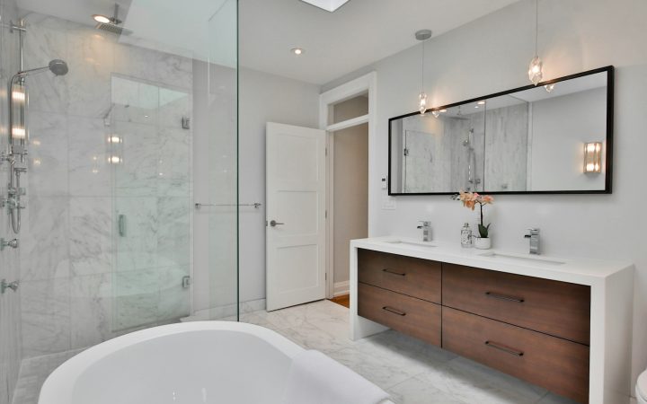 a bathroom with a large white bathtub next to a walk in shower