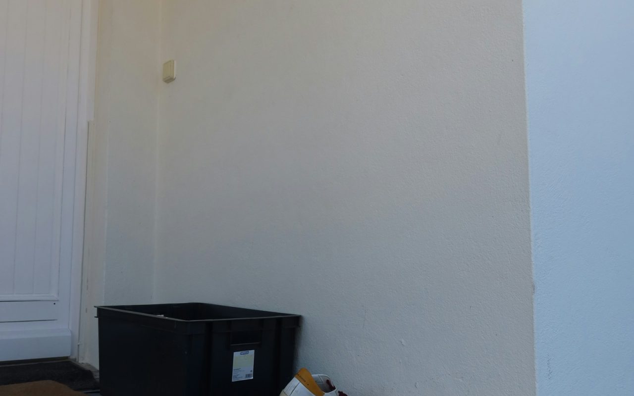 Shoes and a box sit by the door