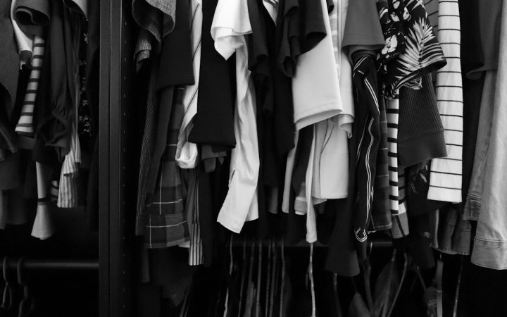 a closet filled with lots of different types of shirts