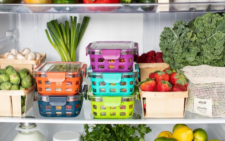 Refrigerator with food grouped in visible containers and shelf zones