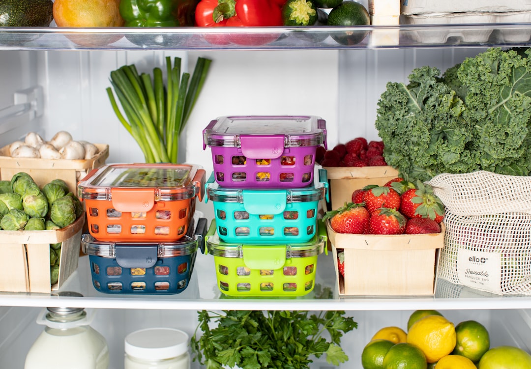Refrigerator with food grouped in visible containers and shelf zones