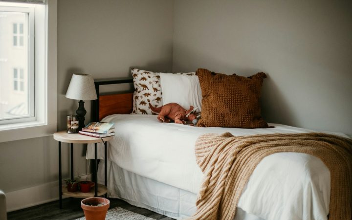 Small bedroom with a clear bed and contained furniture footprint