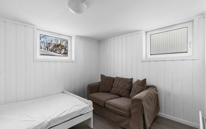 Small room with both couch and bed demonstrating multipurpose guest use