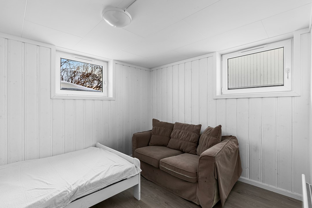 Small room with both couch and bed demonstrating multipurpose guest use