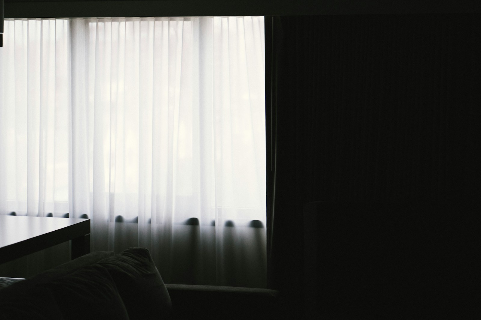 Sheer curtains hanging across a window