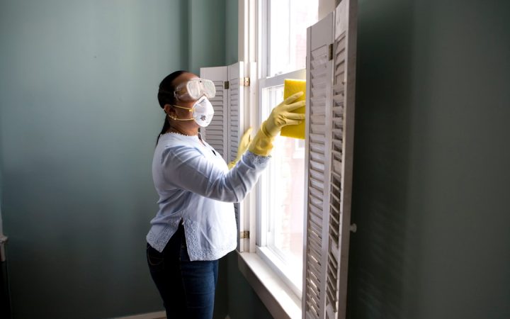 Person cleaning a window sill during a deeper home cleaning session