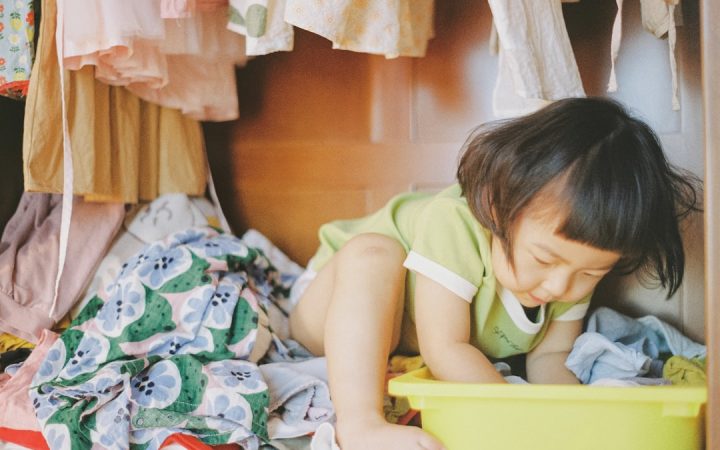 Child beside a bright storage bin illustrating easy-reach kids storage